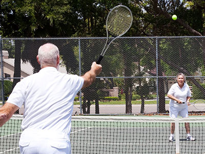 two seniors playing tennis